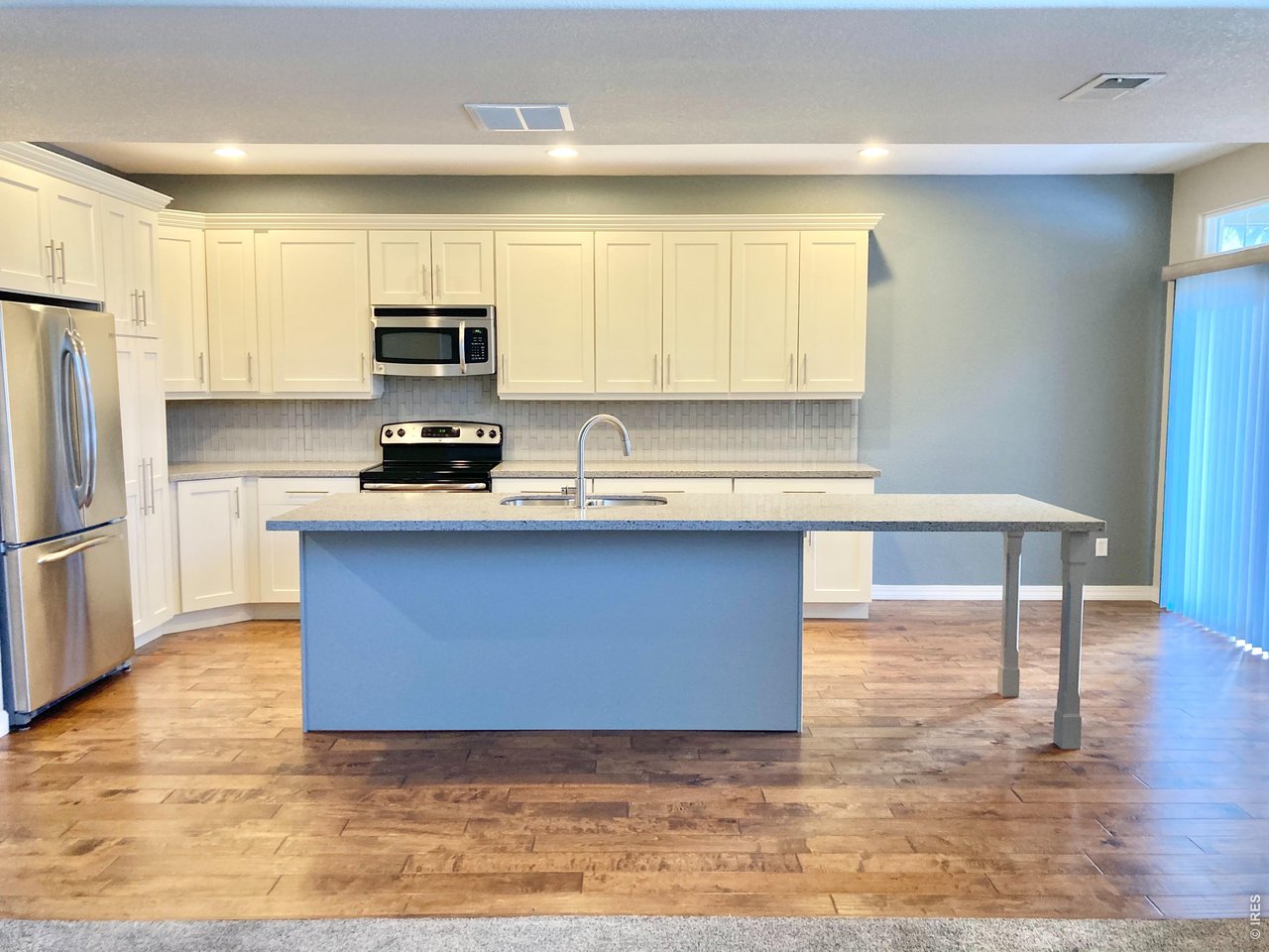 1900 68th Avenue, Unit 5 Greeley, CO 80634 - Photo 5 of 21 a kitchen with stainless steel appliances granite countertop a stove a sink and a refrigerator