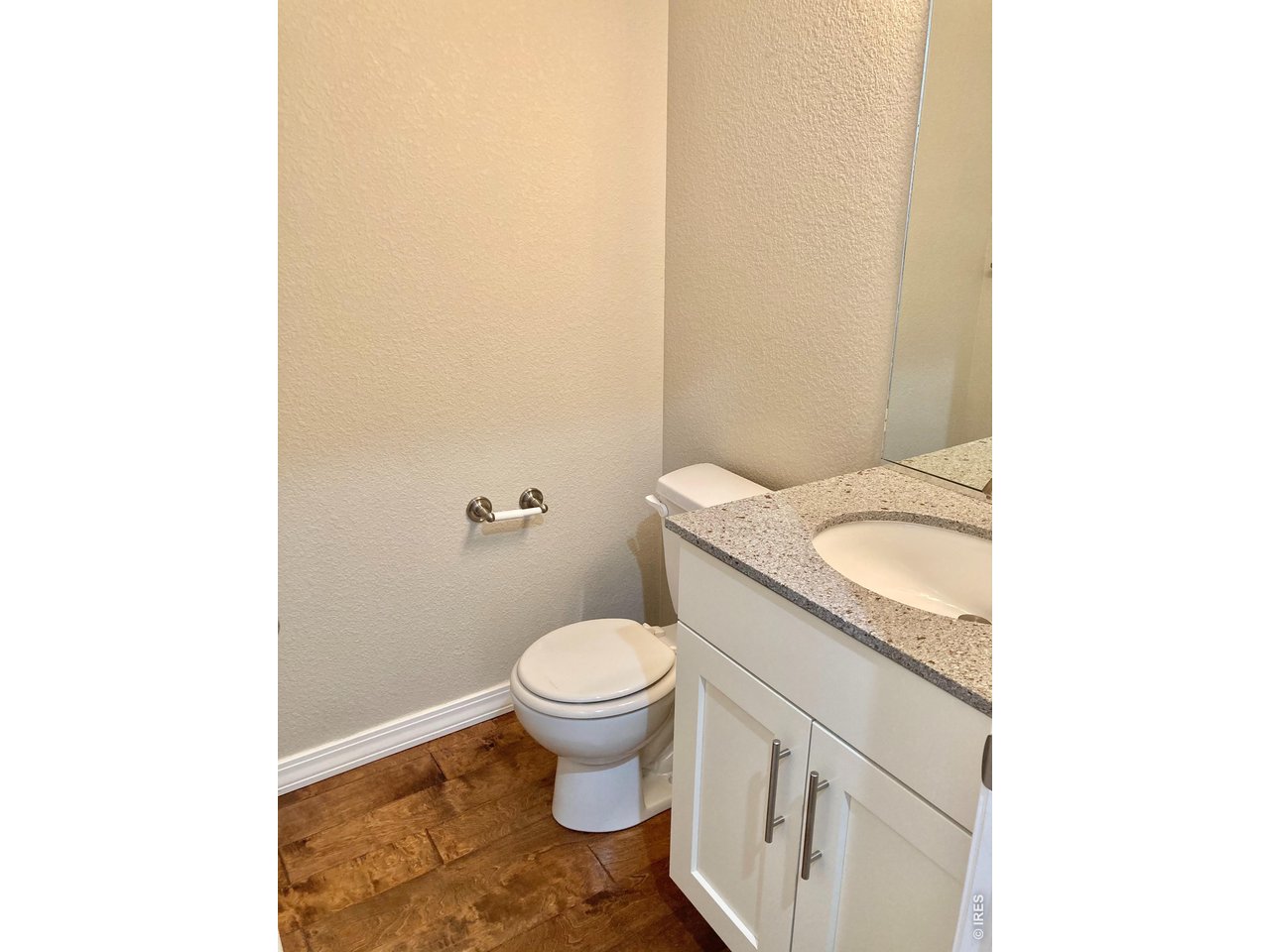 1900 68th Avenue, Unit 5 Greeley, CO 80634 - Photo 8 of 21 a bathroom with a granite countertop toilet and a sink