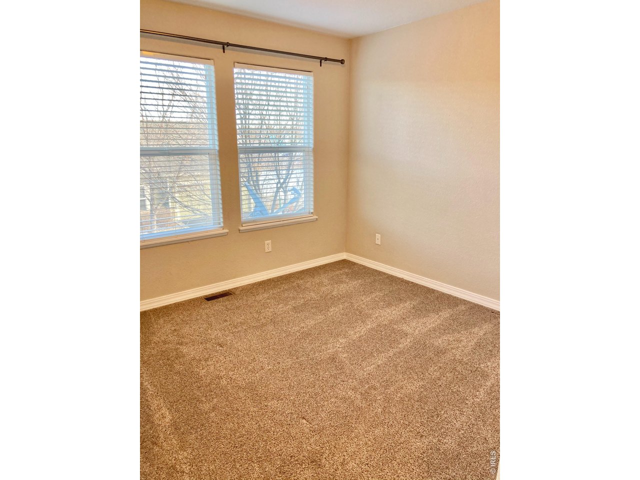 1900 68th Avenue, Unit 5 Greeley, CO 80634 - Photo 9 of 21 a view of an empty room with a window