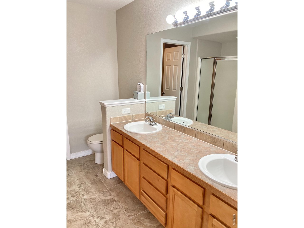 1900 68th Avenue, Unit 5 Greeley, CO 80634 - Photo 10 of 21 a bathroom with a sink and a mirror
