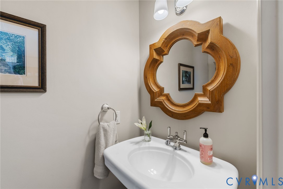 8947 Cherokee Road Richmond, VA 23235 - Photo 20 of 45 a bathroom with a sink and a mirror