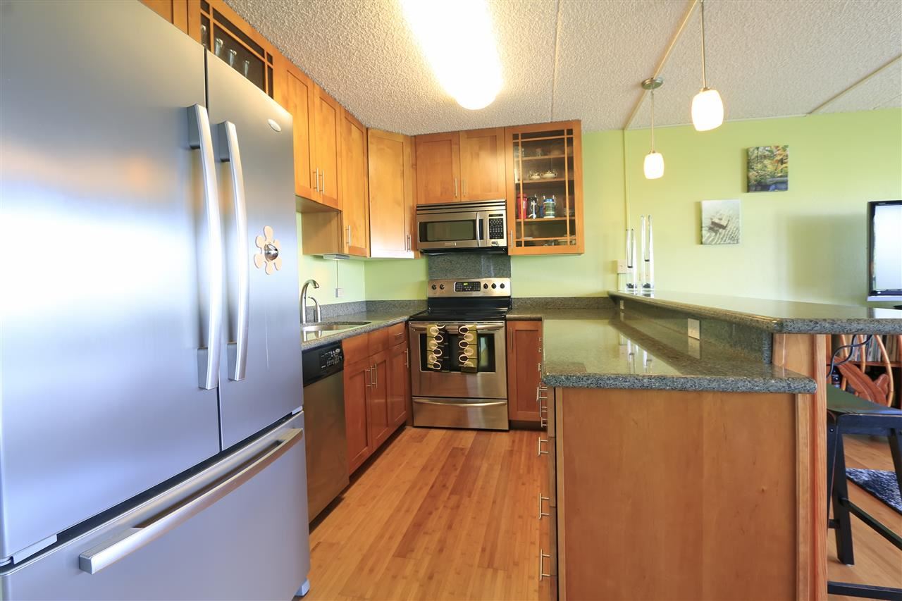 2387 South Kihei Road, Unit C302 Kihei, HI 96753 - Photo 4 of 17 a kitchen with stainless steel appliances granite countertop a refrigerator a stove and a sink