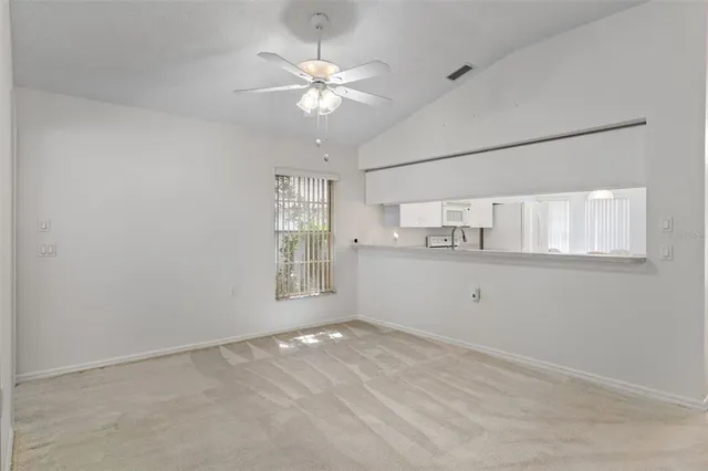 a view of a room with wooden floor and a gate