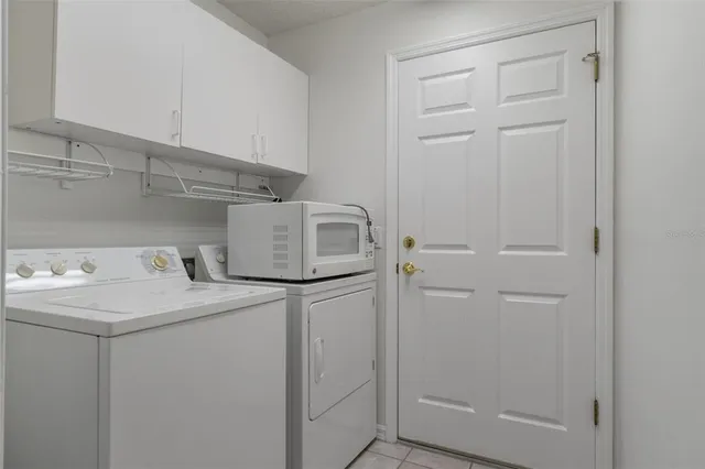 a view of a chair and tables in the patio next to a yard