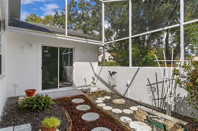 a front view of a house with a yard and potted plants