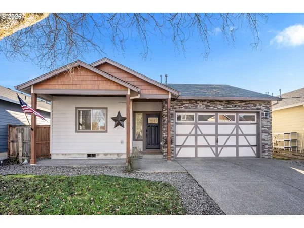 a view of a house with a yard and wooden fence