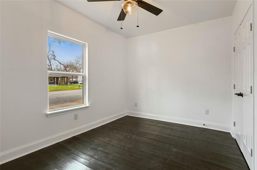 1106 West Chestnut Street Denison, TX 75020 - Photo 14 of 38 Unfurnished room with dark wood-type flooring and ceiling fan