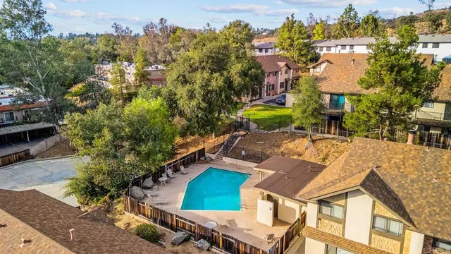 a aerial view of a house next to a big yard