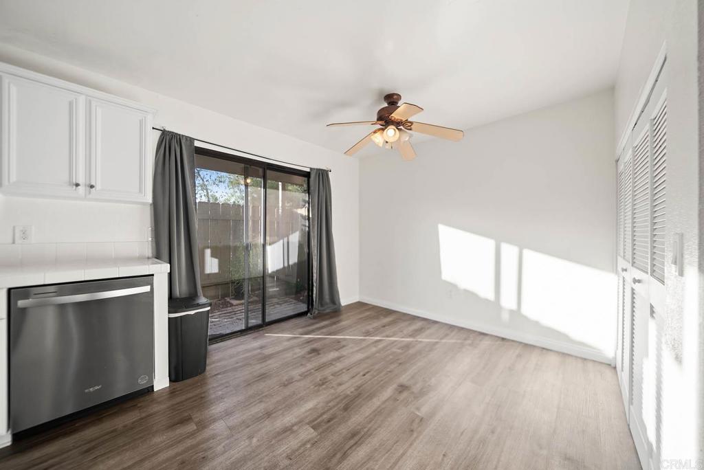 2636 Alpine Boulevard, Unit C Alpine, CA 91901 - Photo 8 of 35 an empty room with wooden floor fan and windows