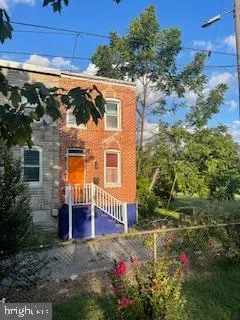 a view of a house with a small yard and potted plants
