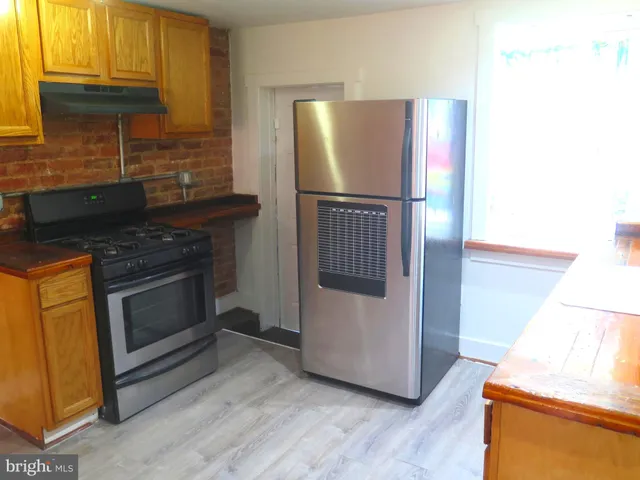a kitchen with granite countertop a refrigerator and a stove