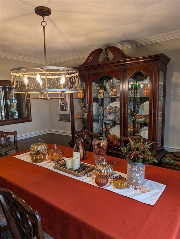 251 Wellman Avenue, Unit 251 Chelmsford, MA 01863 - Photo 13 of 42 a kitchen with a table and chairs in it
