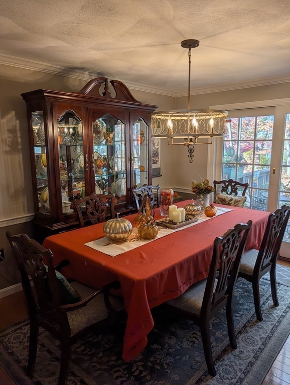 251 Wellman Avenue, Unit 251 Chelmsford, MA 01863 - Photo 14 of 42 a dining room with furniture a chandelier and window