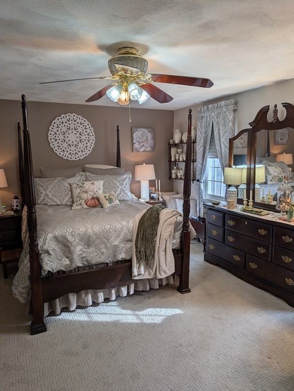 251 Wellman Avenue, Unit 251 Chelmsford, MA 01863 - Photo 18 of 42 a bedroom with a bed and a chandelier