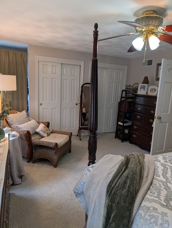 251 Wellman Avenue, Unit 251 Chelmsford, MA 01863 - Photo 19 of 42 a bedroom with bed and a chandelier