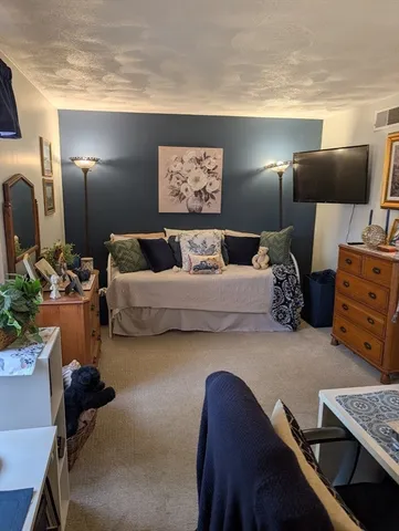 a bedroom with furniture and a lamp