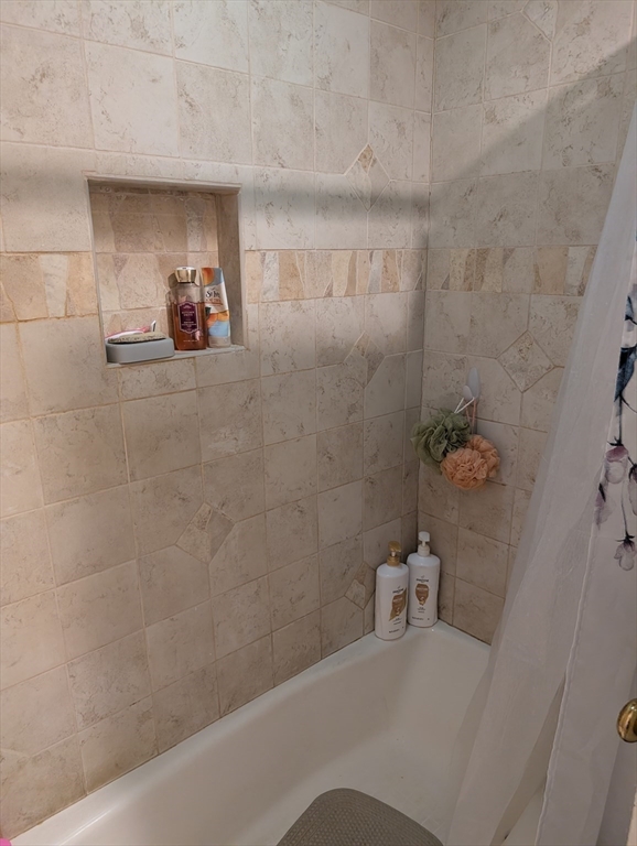 251 Wellman Avenue, Unit 251 Chelmsford, MA 01863 - Photo 27 of 42 a bathroom with a tub