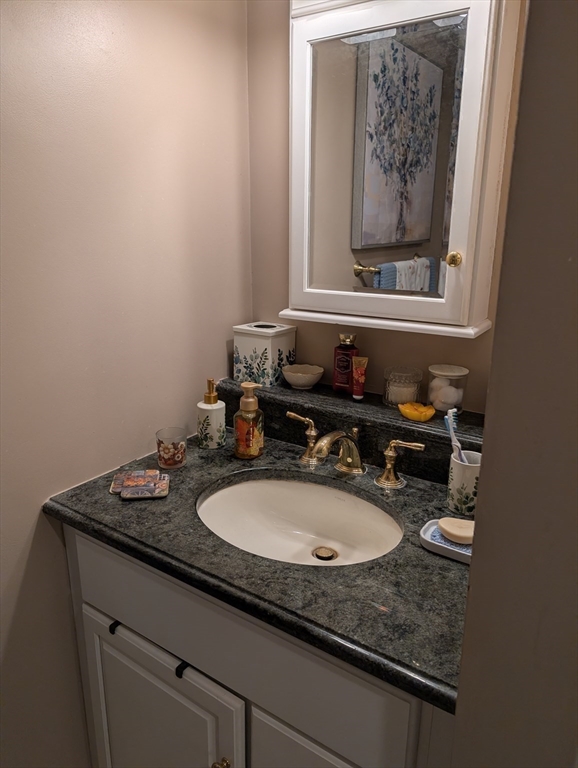 251 Wellman Avenue, Unit 251 Chelmsford, MA 01863 - Photo 28 of 42 a bathroom with a sink and a mirror