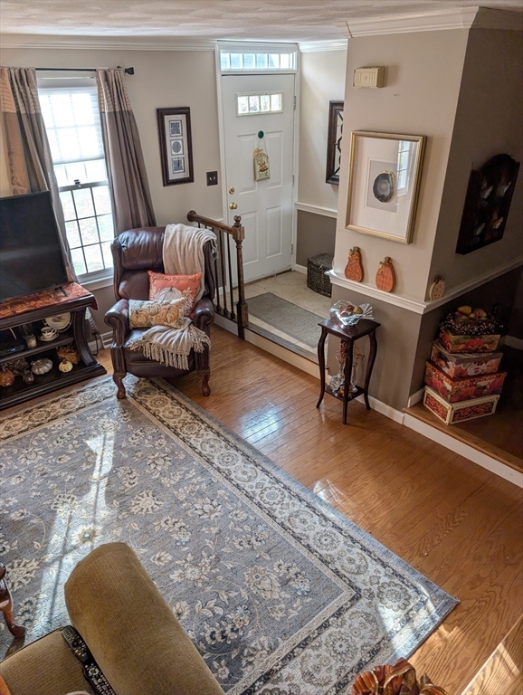 251 Wellman Avenue, Unit 251 Chelmsford, MA 01863 - Photo 6 of 42 a living room with furniture and a flat screen tv