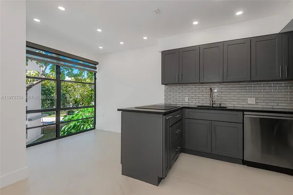 a kitchen with a sink and wooden cabinets