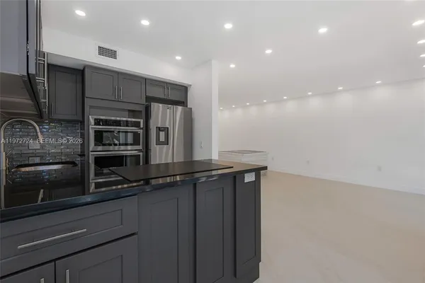 a kitchen with stainless steel appliances a refrigerator and a sink