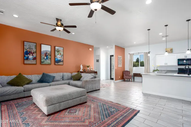 a living room with furniture and a chandelier