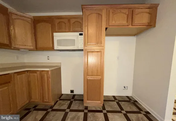 an empty room with a ceiling fan and a window