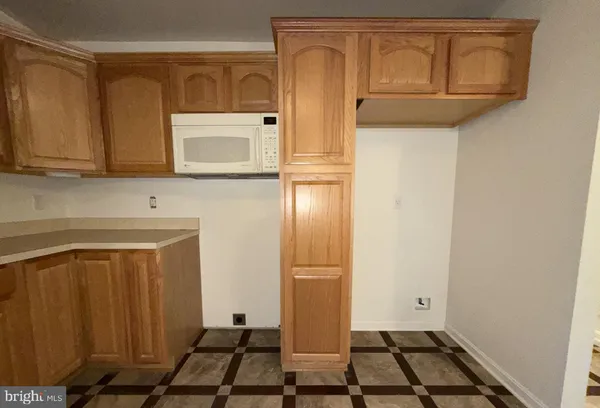 an empty room with a ceiling fan and a window