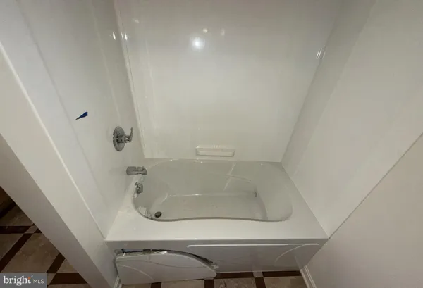 a bathroom with a granite countertop toilet and a shower