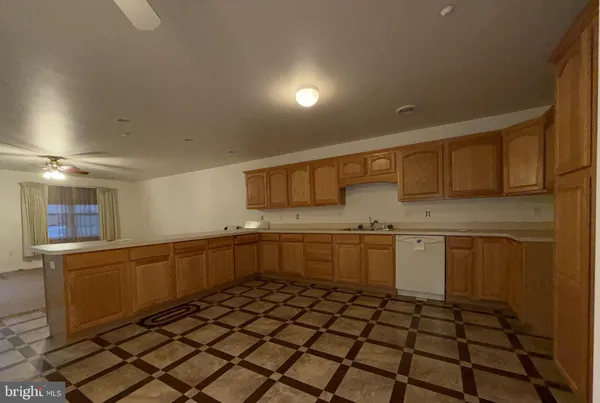 a kitchen with a sink a refrigerator and cabinets