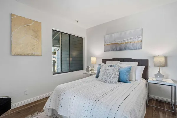 a bedroom with a bed a table and chair