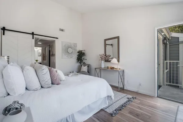 a bedroom with a bed and a large window