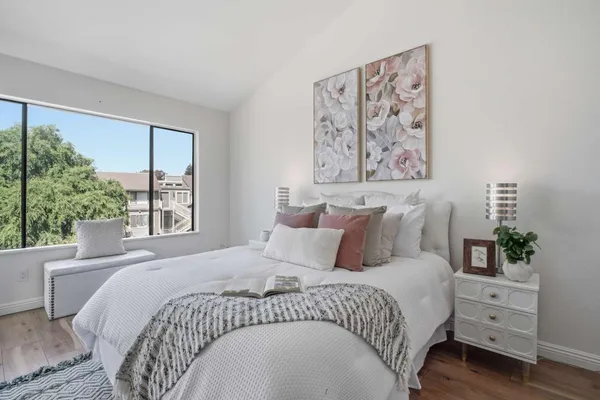 a bedroom with a large bed and a chandelier