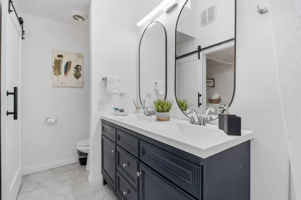 a bathroom with sinks and mirror