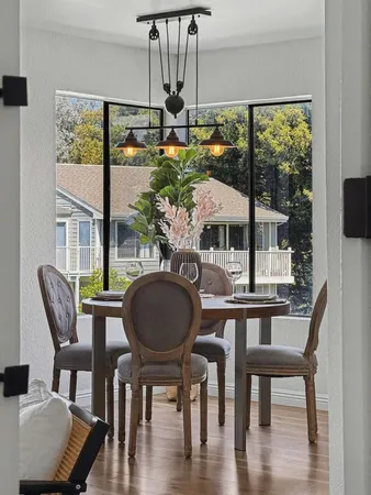 a balcony with wooden floor and outdoor seating