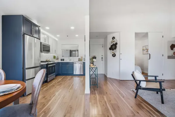 a kitchen with stainless steel appliances kitchen island granite countertop a refrigerator and a stove top oven