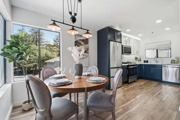 a kitchen with stainless steel appliances granite countertop a refrigerator stove and sink