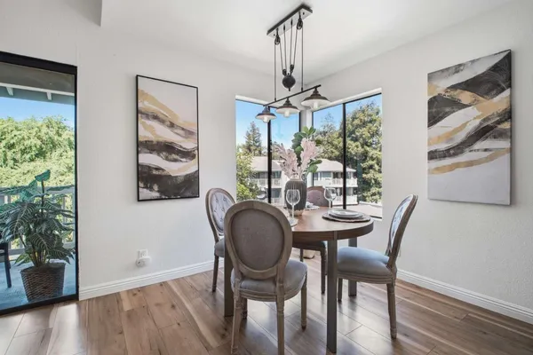 a view of a dining room with furniture window and wooden floor