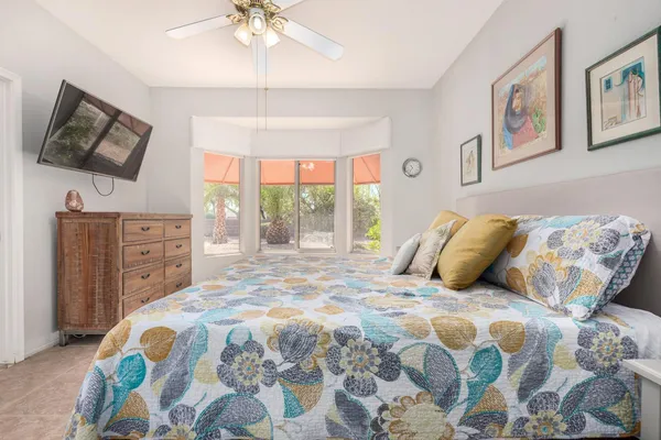 a bedroom with a large bed and a window