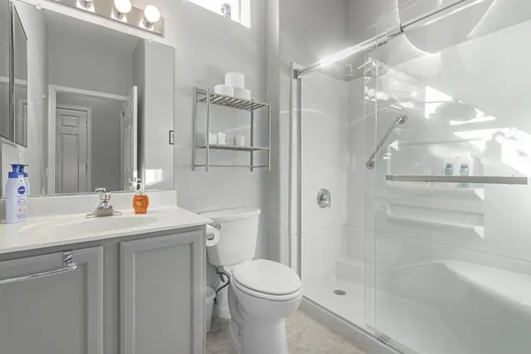 a bathroom with a sink toilet and shower