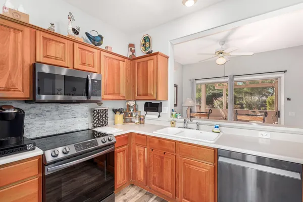 a kitchen with stainless steel appliances a stove a sink and a microwave