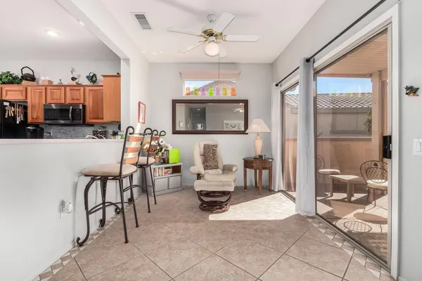 a living room with furniture a flat screen tv and a window