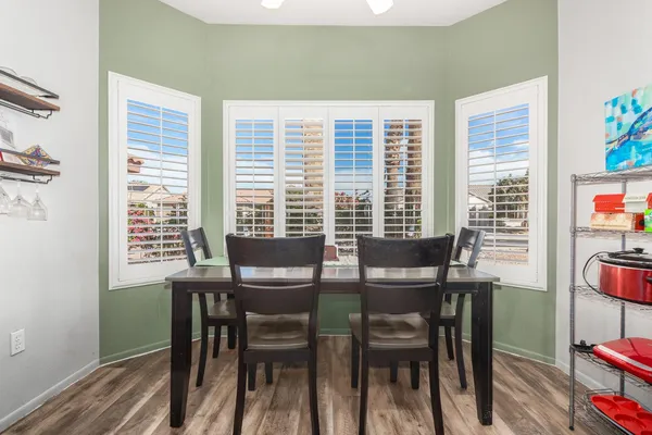 a view of a dining room with furniture and a potted plant