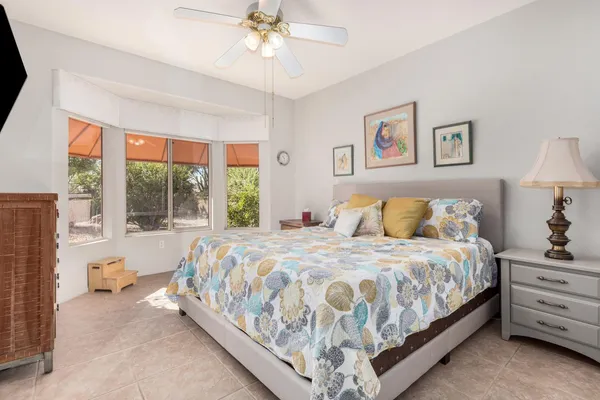 a bedroom with a large bed and a chandelier