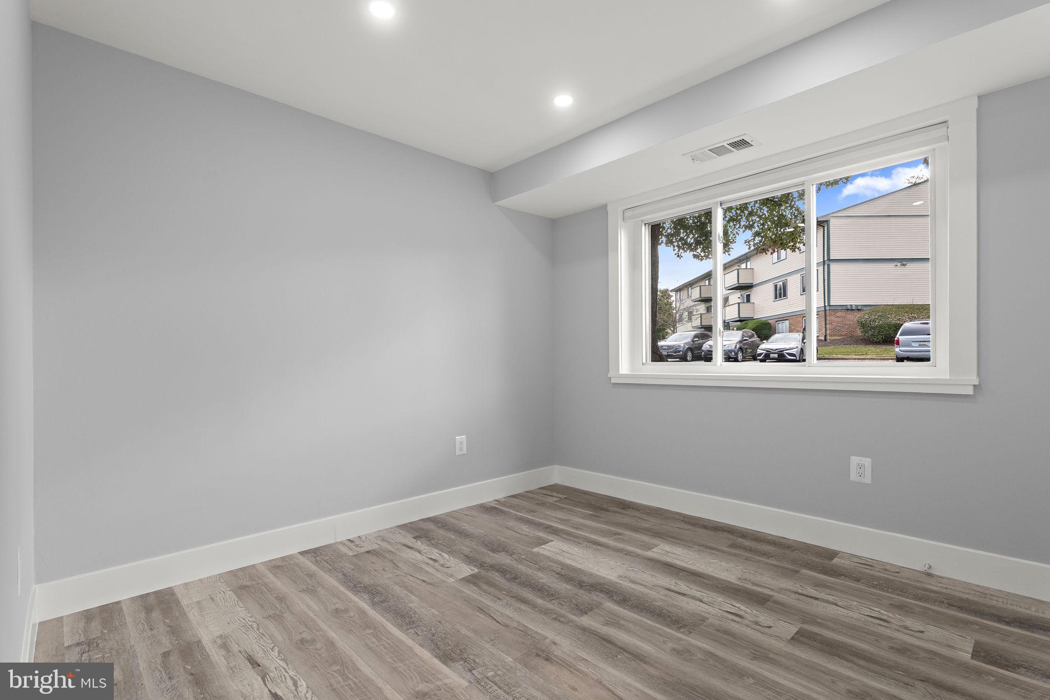 19605 Gunners Branch Road, Unit D Germantown, MD 20876 - Photo 21 of 36 a view of empty room with wooden floor