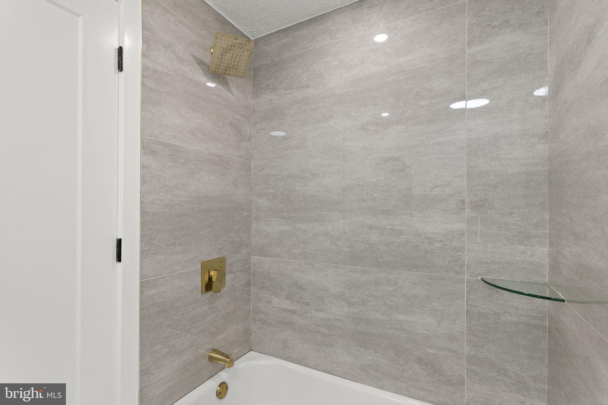 19605 Gunners Branch Road, Unit D Germantown, MD 20876 - Photo 24 of 36 a bathroom with a shower a toilet and a shower