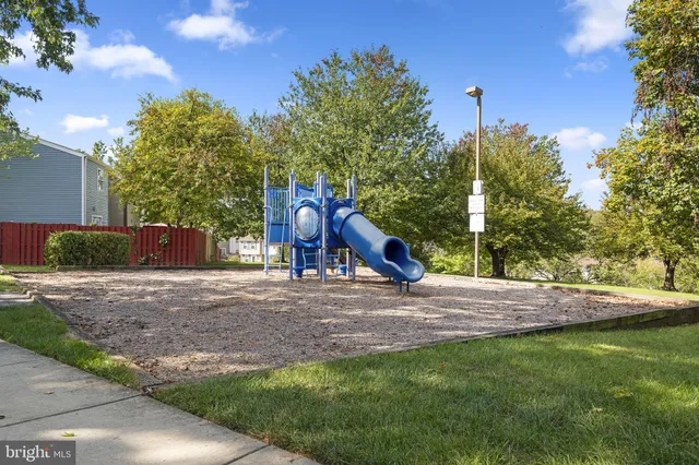 a view of a park with slide and entertaining space
