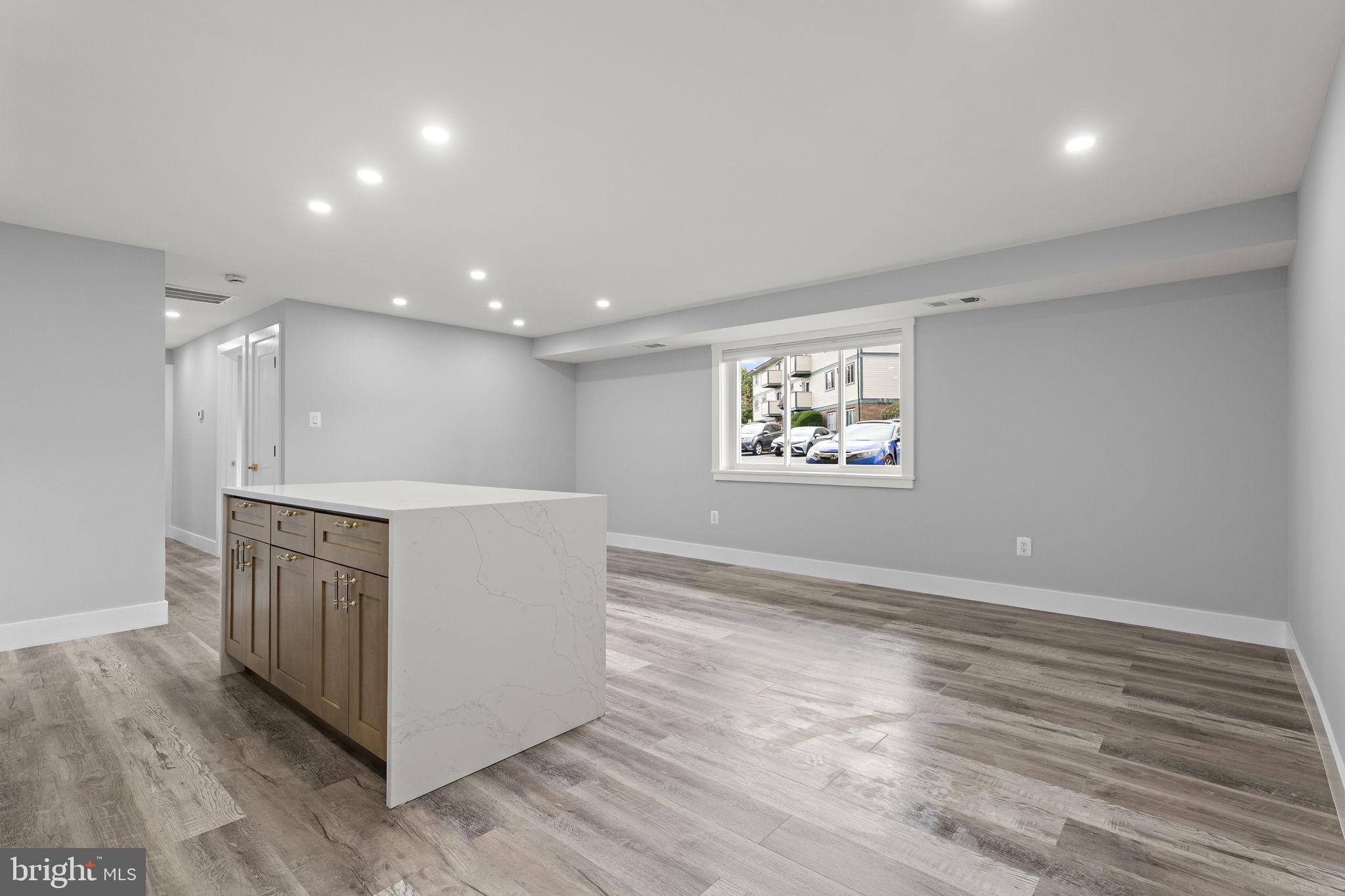 19605 Gunners Branch Road, Unit D Germantown, MD 20876 - Photo 10 of 36 a view of an empty room with wooden floor and a window
