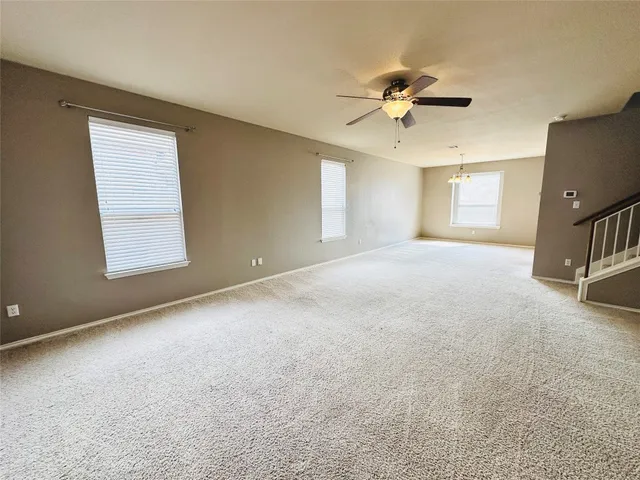a view of a livingroom with a ceiling fan and window