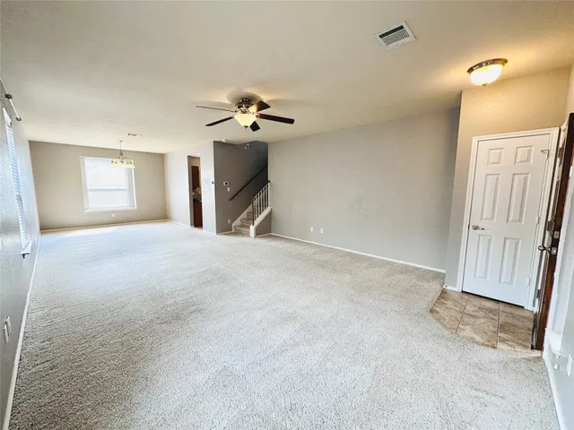 a view of a livingroom with a sink and a chandelier fan